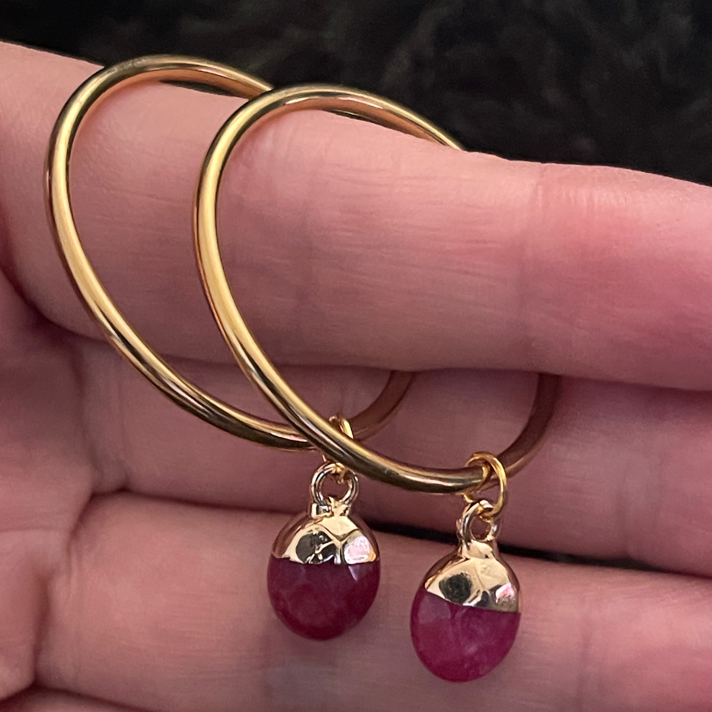 Medium gold hoop earring with a deep pink Quartz crystal.