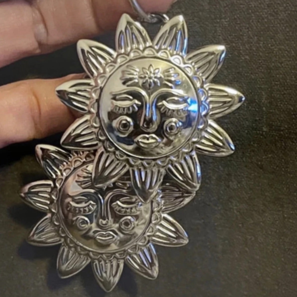 Silver hoop earrings with an X LARGE silver sunbeam with face detail.