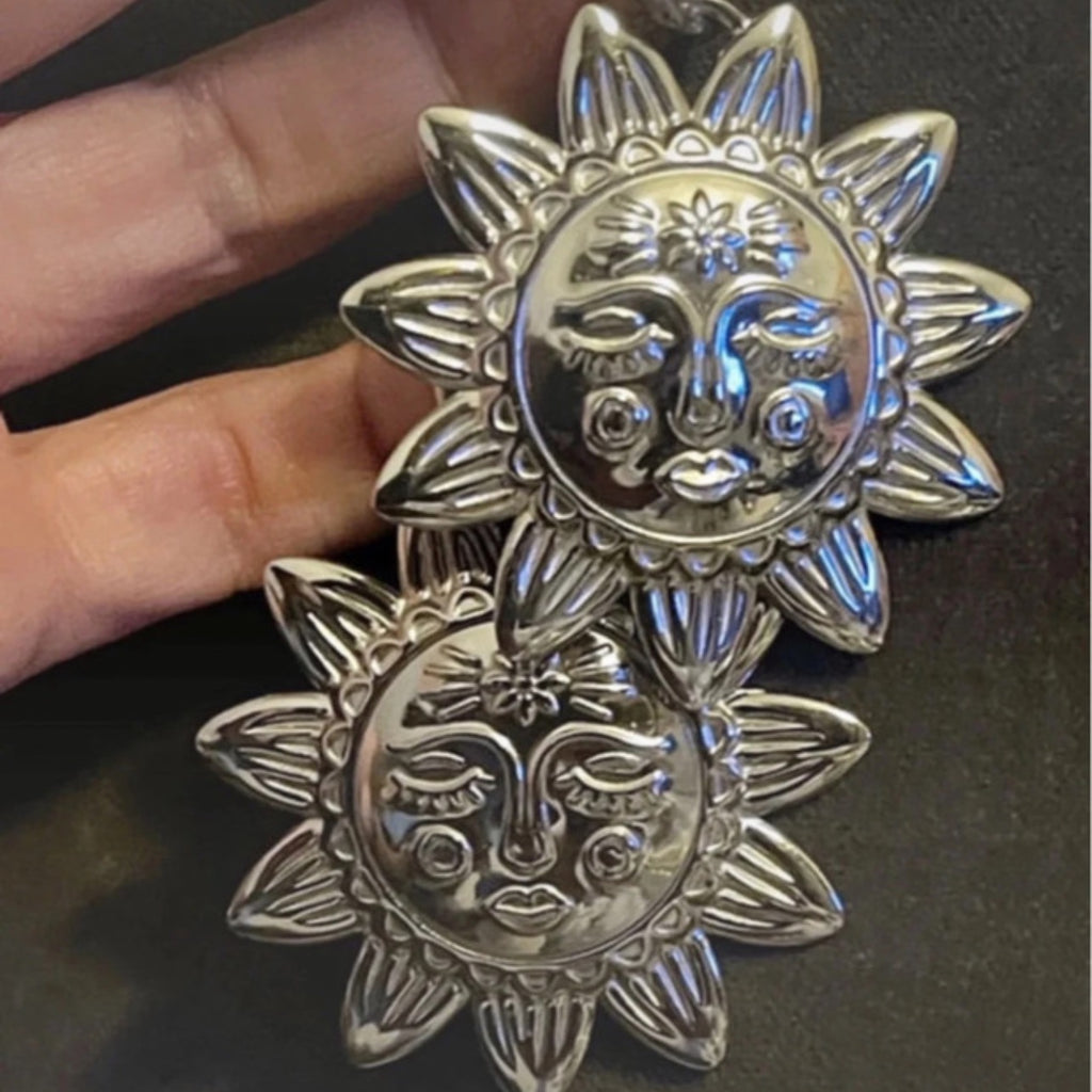 Silver hoop earrings with an X LARGE silver sunbeam with face detail.