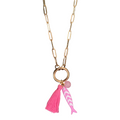 Necklace with pink tassel and fish charm on a white background