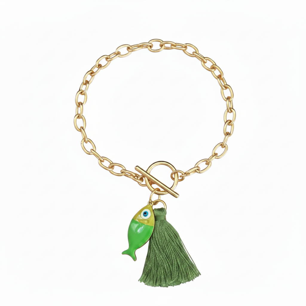 Gold bracelet with a green fish and green tassel on a white background.