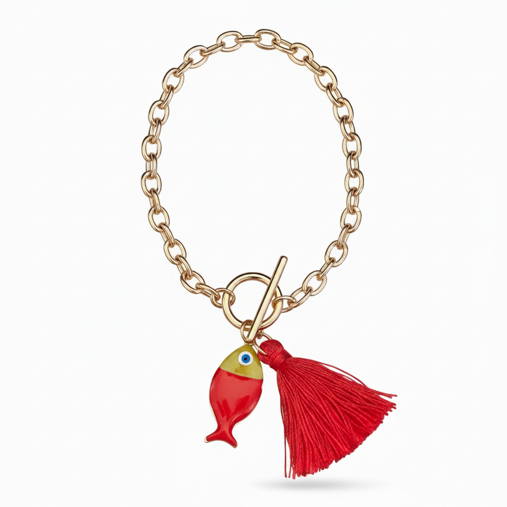 Gold link bracelet with a red fish and red tassel on a white background.