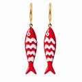 Red fish-shaped earrings with white wave patterns on a gold hook against a white background