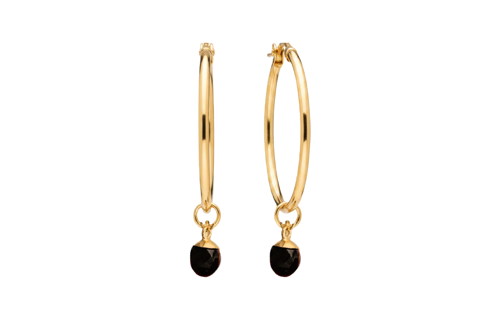 A pair of gold hoop earrings with a small oval black agate crystal against a white background