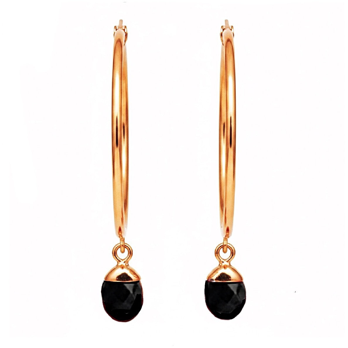 Gold hoop earrings with black crystals on a white background