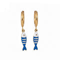 Gold hoop earrings with blue and white striped fish on white background 