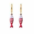 Gold hoop earrings with red and white fish-shaped charms on a white background