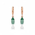 Gold hoop earrings with green and white fish charms on white background 