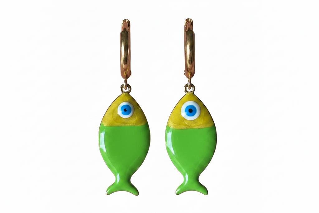 Green fish-shaped earrings with blue eyes on a white background