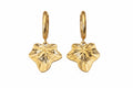 A pair of gold hoop earrings featuring textured ivy leaf charms shown against a plain white background.