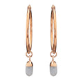 Gold hoop earrings with dangling opal crystals on a white background