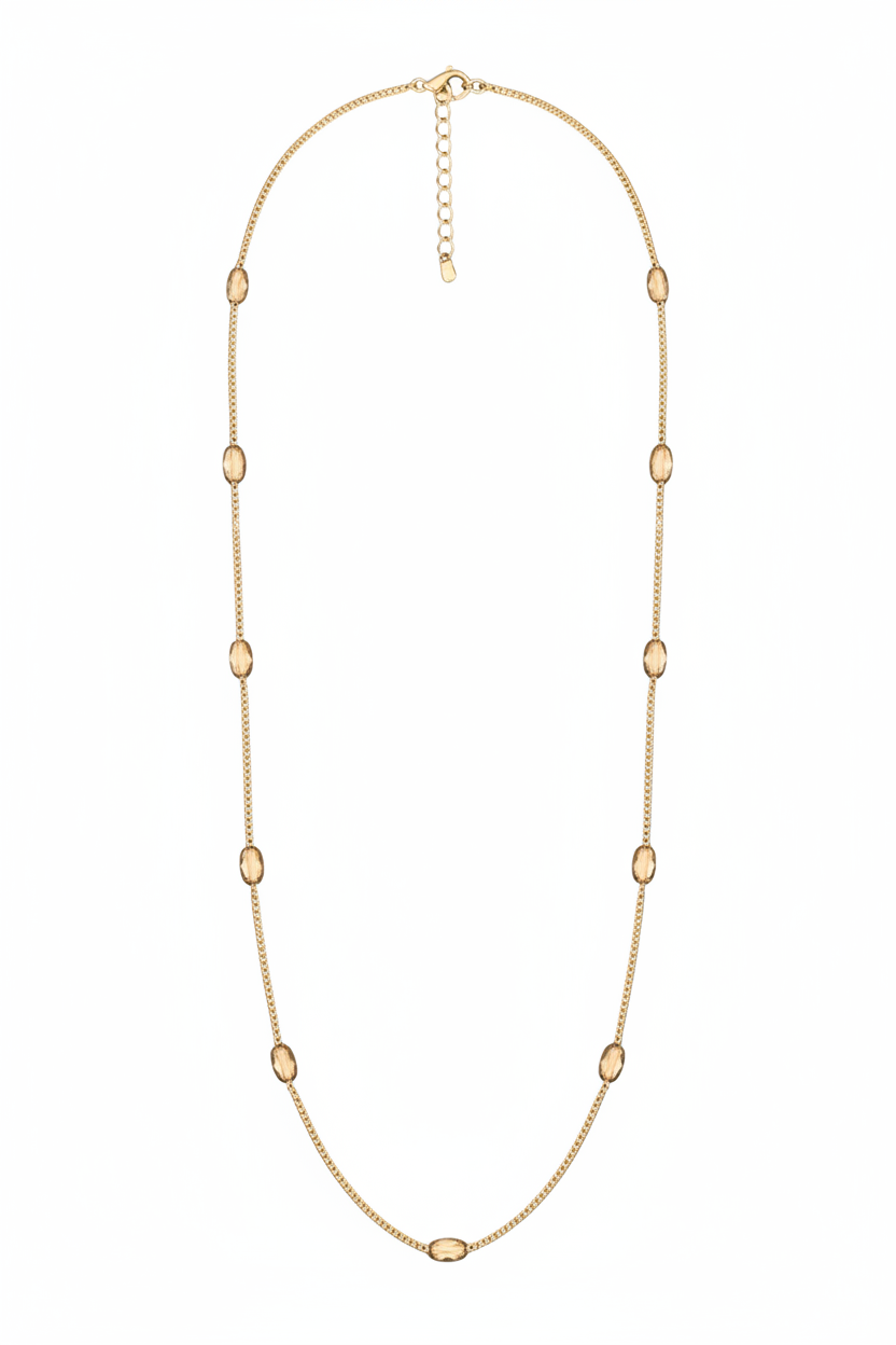 Gold necklace with small beads on a white background