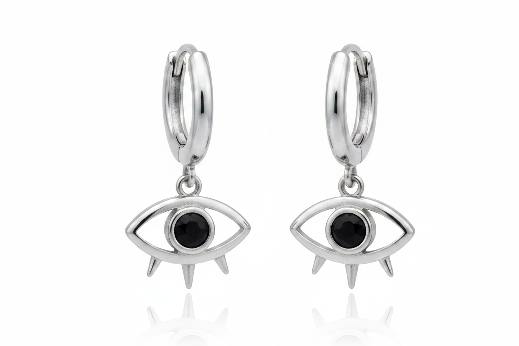 Silver hoop earrings with eye-shaped charms on a white background