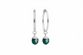 A pair of silver hoop earrings with a turquoise oval crystal against a white background 