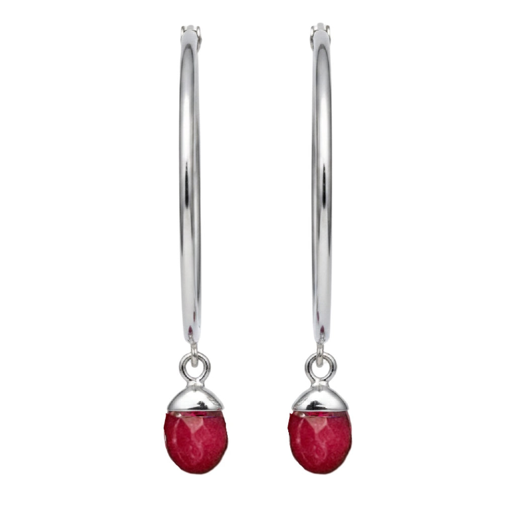 Silver earrings with red gemstones on a white background