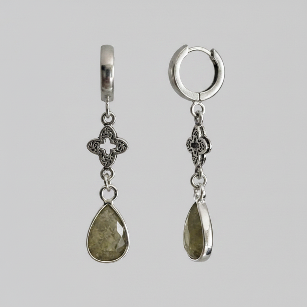 Pair of silver hoop earrings with teardrop-shaped gemstones on a gray background