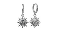 Pair of silver sun-shaped earrings with face designs on a white background