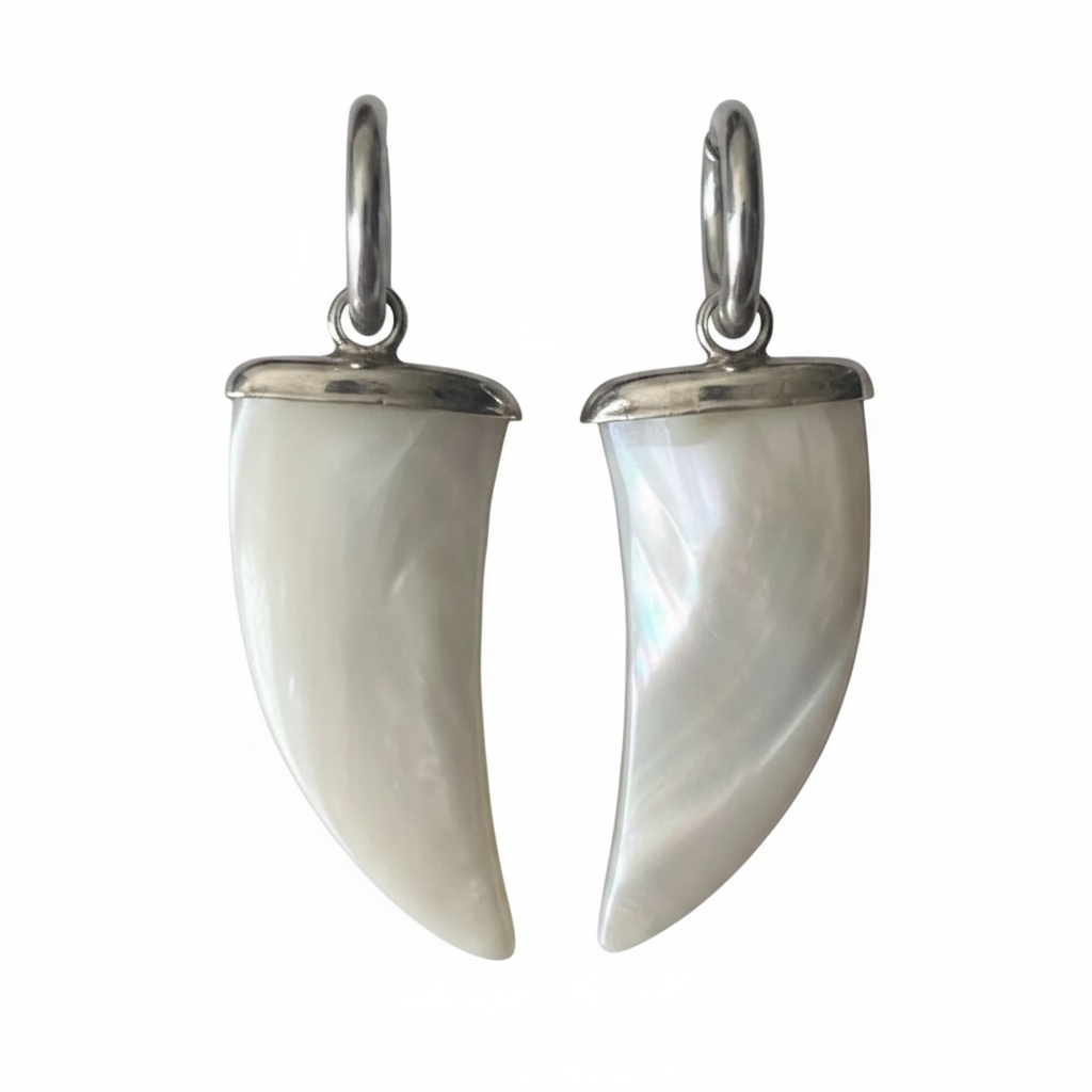 Pair of white horn-shaped earrings with silver hooks on a white background
