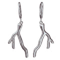 Silver coral-like earrings on a white background