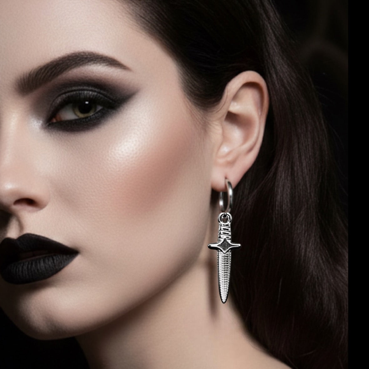 Close-up of a woman wearing a unique earring with a dark background
