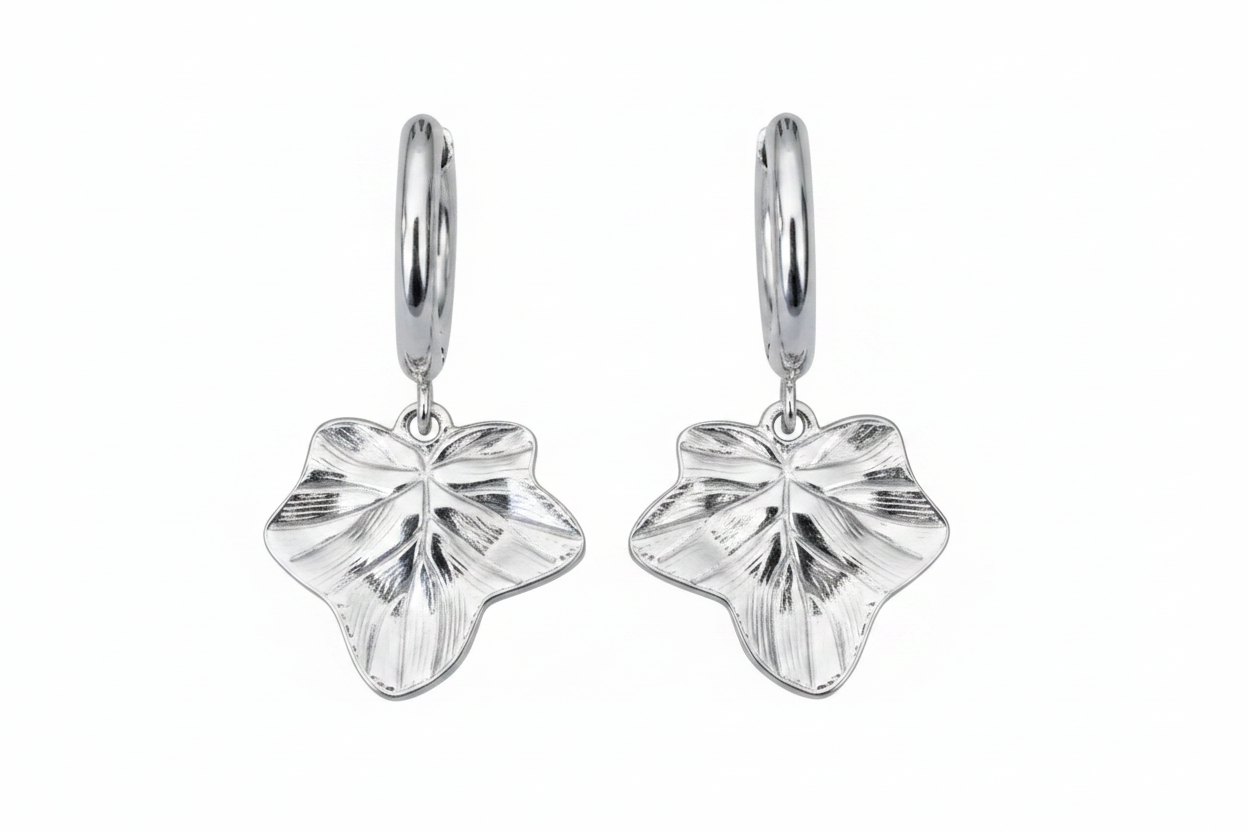 Pair of silver leaf-shaped earrings on a white background