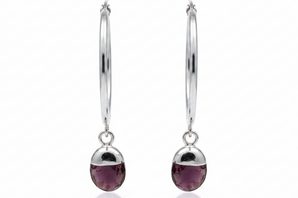 Silver hoop earrings with purple amethyst crystals on white background 