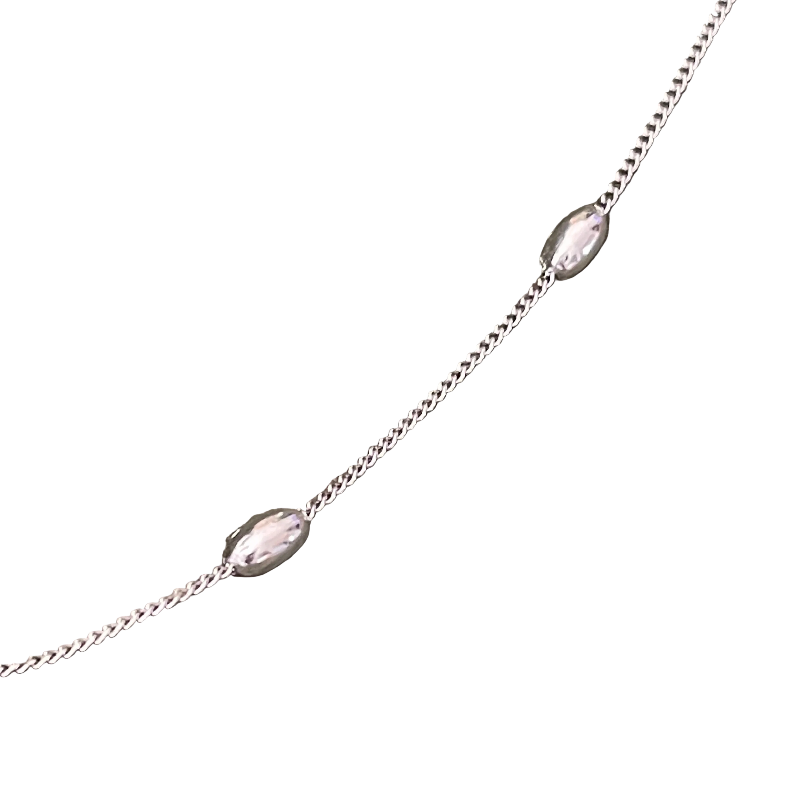 Delicate silver chain necklace with small pink beads on a white background