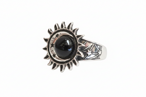 A silver ring featuring a sunburst and moon design with a central black round stone and star details on the band, shown against a plain white background.